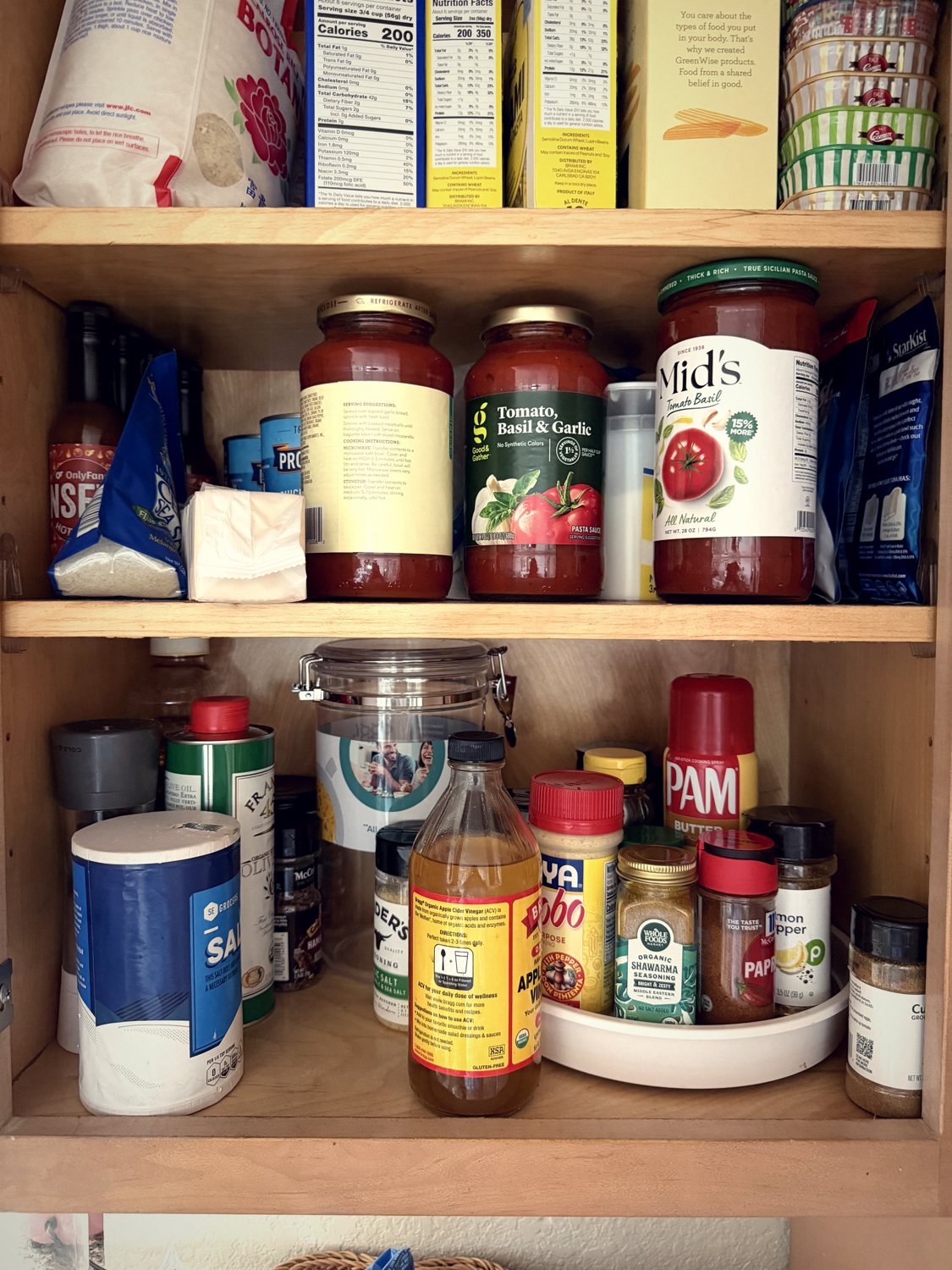 A pantry shelf of pasta sauces